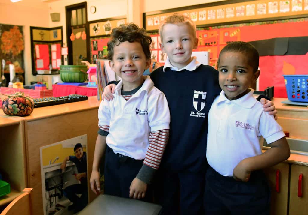 three male preschool students smiling