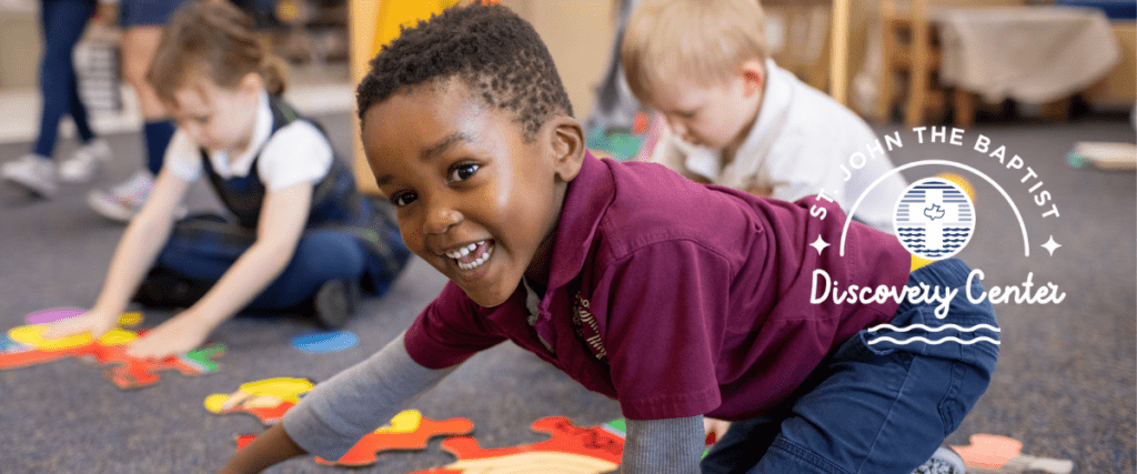male preschool student smiling in marroon shirt